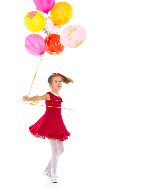 Little girl with helium balloons. - Foto, afbeelding