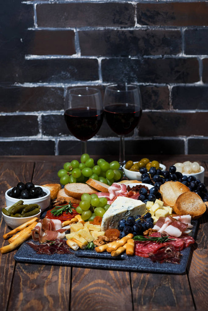 assorted cheeses, fruit and meats to wine, vertical photo - Foto, imagen
