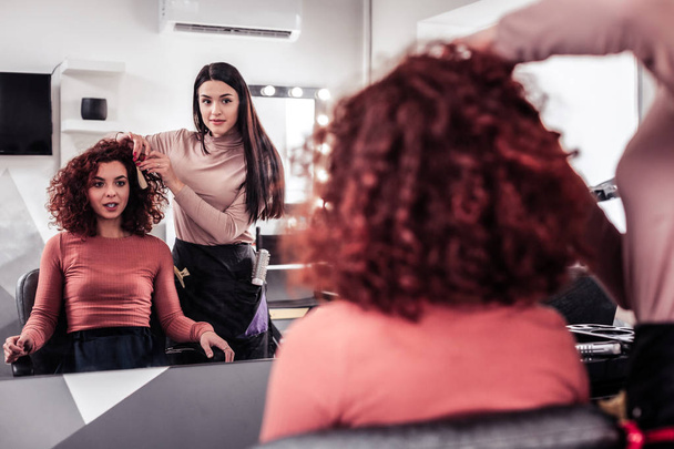 Joyful positive woman visiting a hair stylist - Photo, Image
