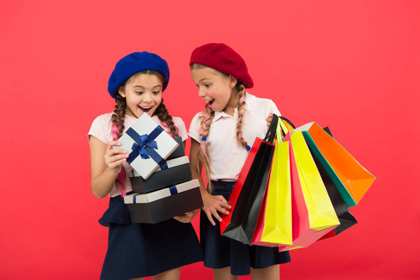 Shopping concept. Child cute small girls on shopping tour. Best price. Buy now. Visit shopping mall. Kids girls hold bunch shopping bags or birthday gifts packages. Dreams come true. Happy childhood - Foto, Bild