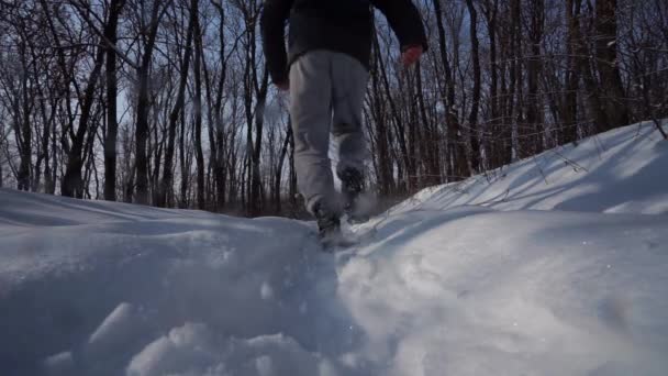 Člověk aby tempo přes kameru, na obloze muž procházky ve sněhu, zadní pohled, boty trail detail. pohled zdola - Záběry, video