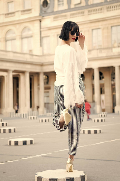 Woman pose on high heel shoes in paris, france. Sensual woman with brunette hair. Beauty girl with glamour look. Fashion model in sunglasses on square. Fashion beauty and vogue - Photo, Image