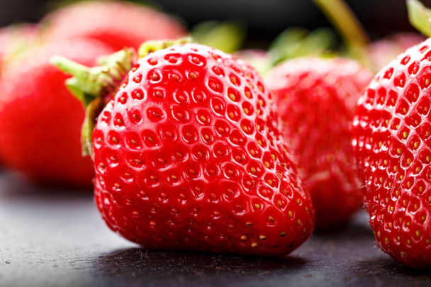 A lot of ripe strawberries scattered on a black background. space for tex - 写真・画像
