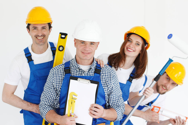 Team of happy smiling workers with tools and contract - Foto, Imagem