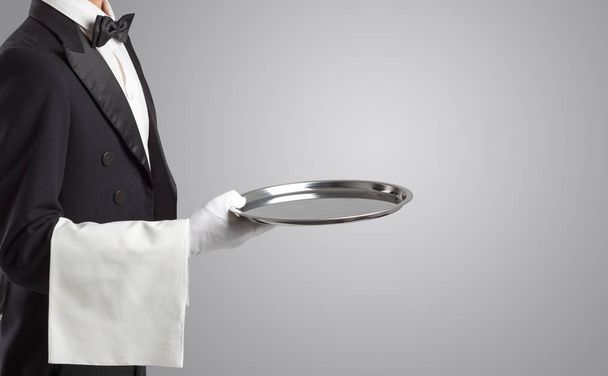 Waiter serving with white gloves and steel tray - Foto, afbeelding