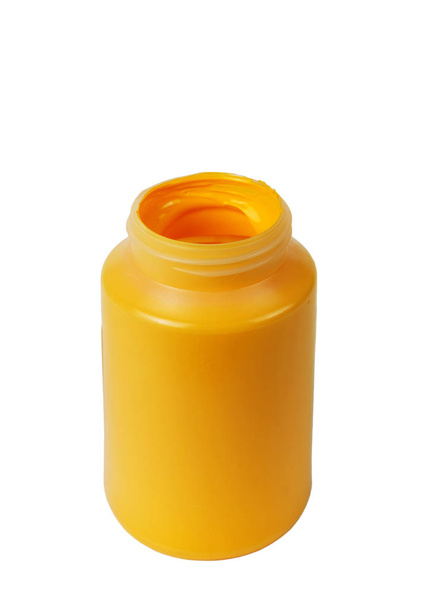 Darh yellow acrylic paint in the plastic container, isolated white background - Фото, зображення