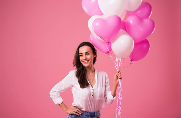 Happy beautiful cute lovely woman with colorful balloons and gift in hands is have a fun and celebration. Birthday, Holidays, St Valentines day and other - Foto, afbeelding