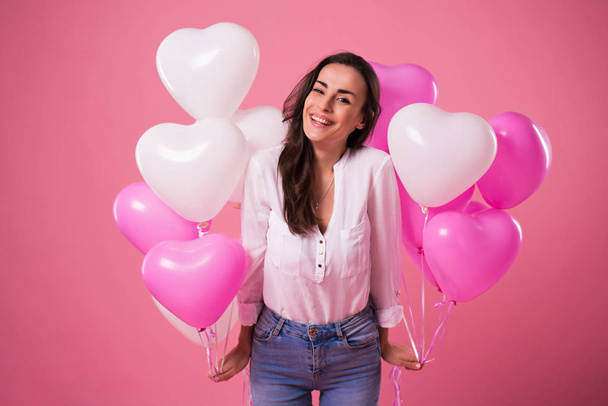 Happy beautiful cute lovely woman with colorful balloons and gift in hands is have a fun and celebration. Birthday, Holidays, St Valentines day and other - 写真・画像