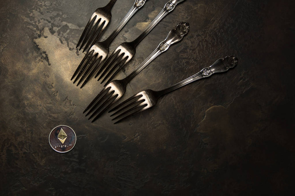 Crypto currency Ethereum and silver forks on dark background - Фото, зображення