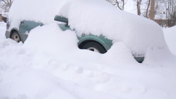 Car covered by snow, under severe winter storm. Cars in the yard under the snow - Footage, Video