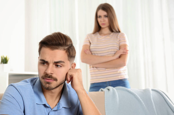 Young couple arguing in living room. Relationship problems - Photo, image