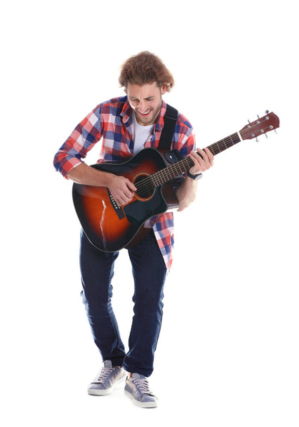 Young man playing acoustic guitar on white background - Foto, immagini