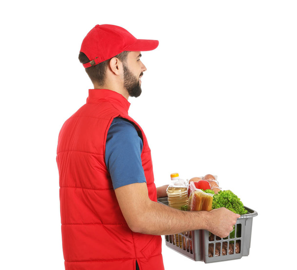 Man holding basket with fresh products on white background. Food delivery service - Foto, afbeelding