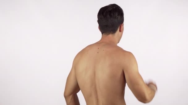 Rearview πλάνο του μια μυϊκή αρσενικό αθλητής που πάσχουν από το λαιμό και πόνο στην πλάτη - Πλάνα, βίντεο