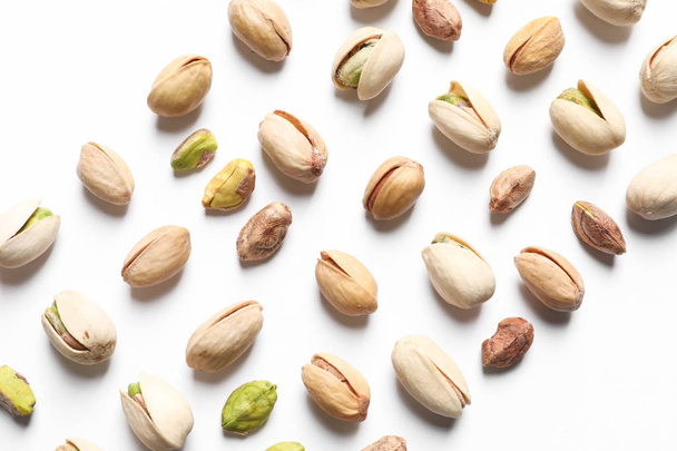 Composition with organic pistachio nuts on white background, top view - Foto, immagini