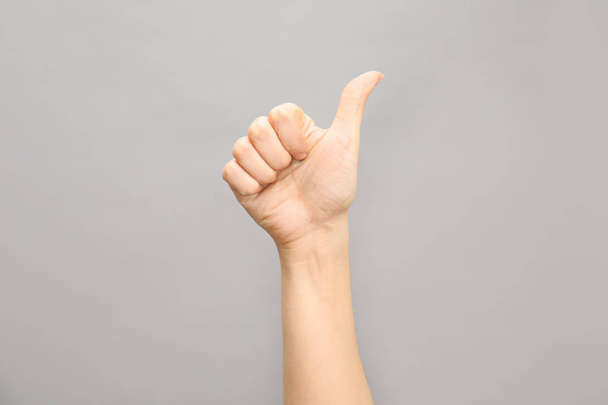 Woman showing number ten on grey background, closeup. Sign language - Фото, изображение