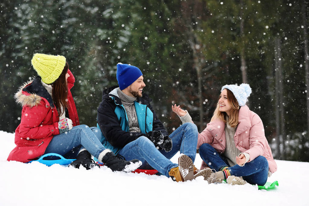 Group of excited friends with backpacks enjoying mountain view during winter vacation - Photo, Image