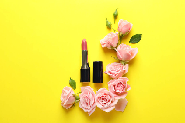 Flat lay composition with lipstick and roses on color background - Φωτογραφία, εικόνα