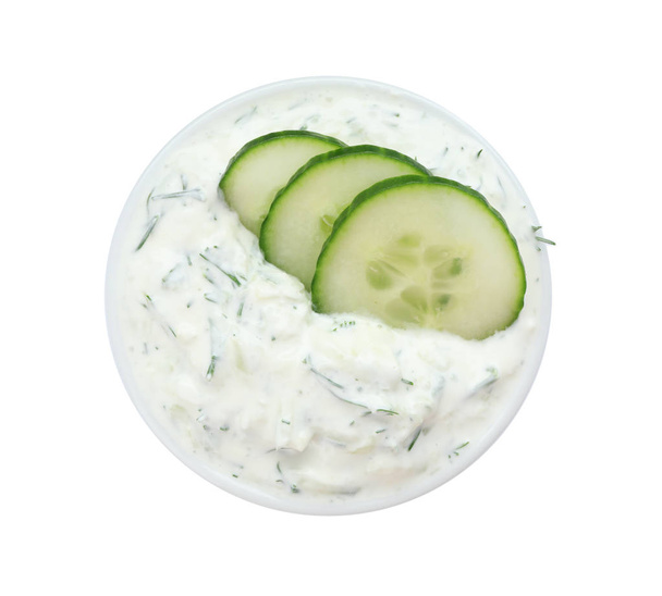 Bowl with cucumber sauce on white background, top view - Zdjęcie, obraz