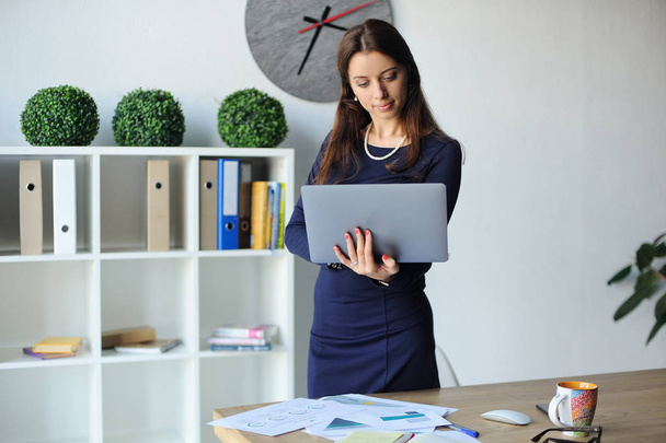 Portrait of a serious businesswoman using laptop in office - Fotó, kép