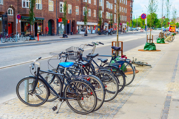 Copenhagen city street with bicycles parking at sidewalk, focus on foreground, Denmark - Фото, зображення
