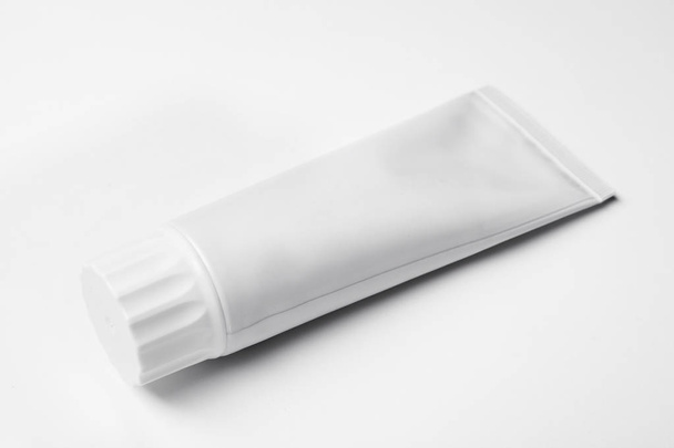 Blank tube of toothpaste on white background - Fotó, kép