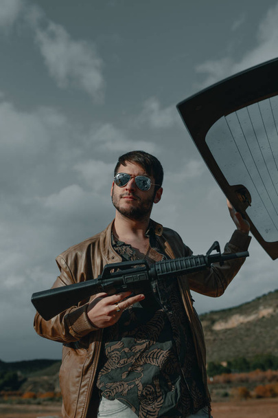 Man with a gun. Man with assault rifle. Man with machine gun. - Foto, Bild