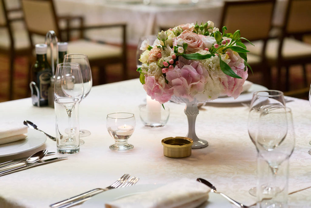 tables served and decorated with flowers for a wedding dinner - Photo, image