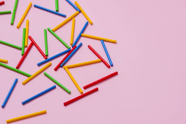 Colorful wooden sticks against pink background - Photo, Image