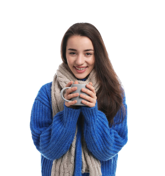 Young woman wearing warm clothes on white background. Winter season - Foto, Bild