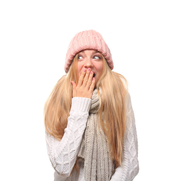 Portrait of emotional young woman in stylish hat and sweater with scarf on white background. Winter atmosphere - Photo, Image