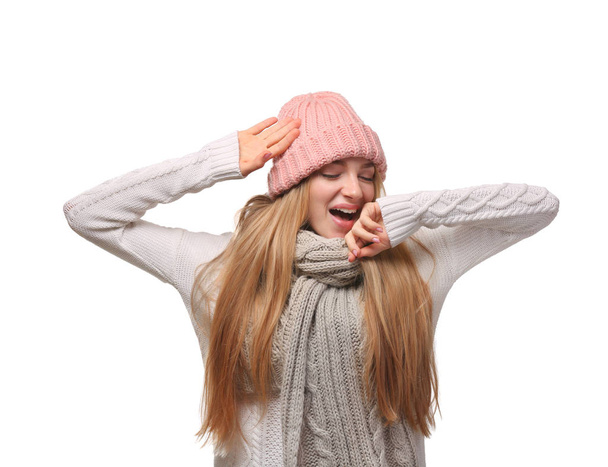 Portrait of emotional young woman in stylish hat and sweater with scarf on white background. Winter atmosphere - Fotó, kép