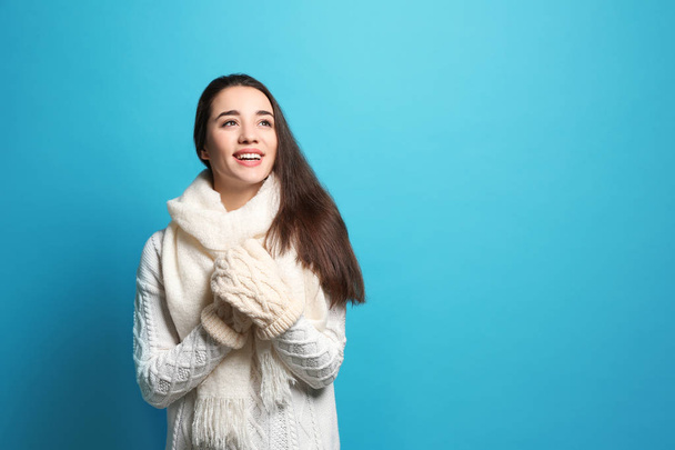 Young woman wearing warm clothes on white background. Winter season - Foto, immagini