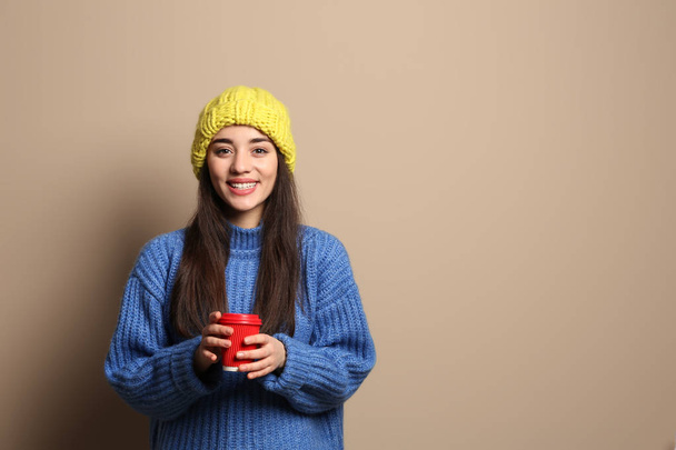 Young woman wearing warm clothes on white background. Winter season - Foto, afbeelding