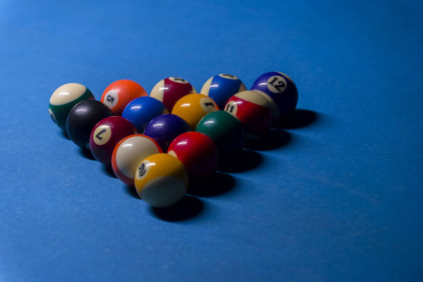 Colorful billiards balls. Billiard ball at blue table. Colorful American pool snooker balls background. American Billiard in bar. Close up Billiard balls. Bar game. Billiard table game. - Фото, зображення