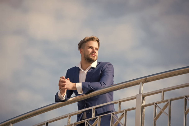 Businessman successful entrepreneur in suit walks outdoor sunny day, sky background. Businessman attractive appearance looks successful. Freedom concept. Man confident and well groomed enjoy freedom - Фото, изображение