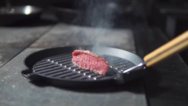 raw meat fried in a pan - Footage, Video