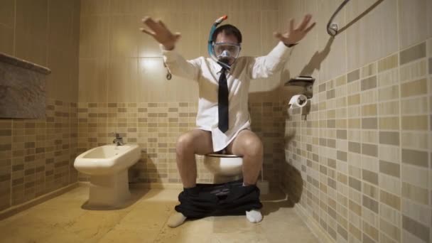 Businessman in diving mask in the restroom - Footage, Video