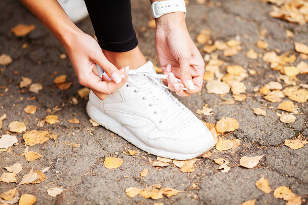 In forma. Femmina corridore legare le scarpe preparare per un jogging
 - Foto, immagini
