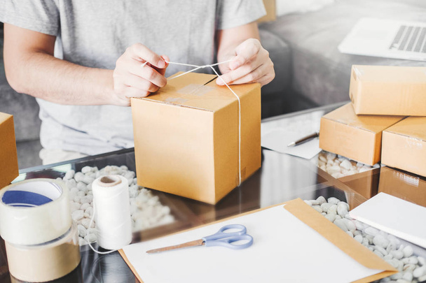 SME freelance man working with packaging startup entrepreneur small business owner at home,Online business seller packaging and delivery concept - Foto, Imagen