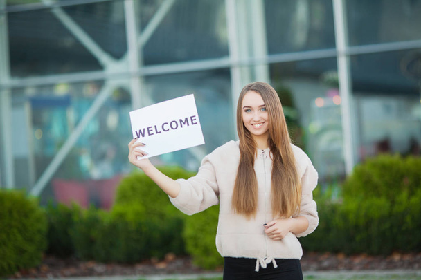 Women business with the poster with welcome message - Photo, Image