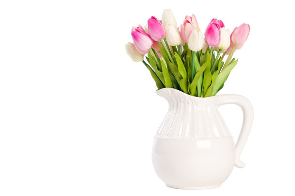 white tulips in a vase on a white background. - 写真・画像