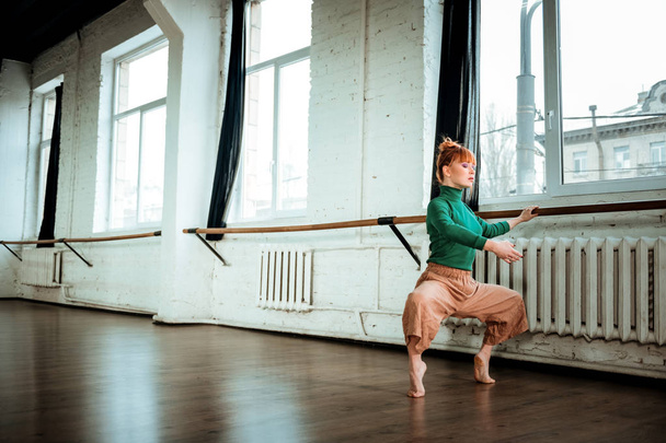 Young professional modern dancer with red hair looking involved - Фото, зображення