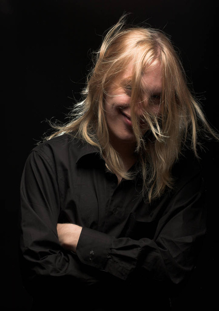 Young man with long blond hair - 写真・画像