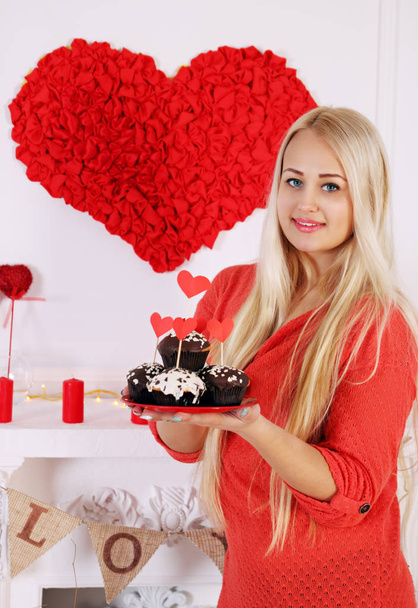 Long-haired blonde holding a festive dessert for Valentines Day - Valokuva, kuva