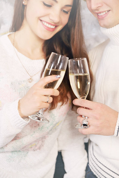 man and woman are holding champagne glasses - Φωτογραφία, εικόνα