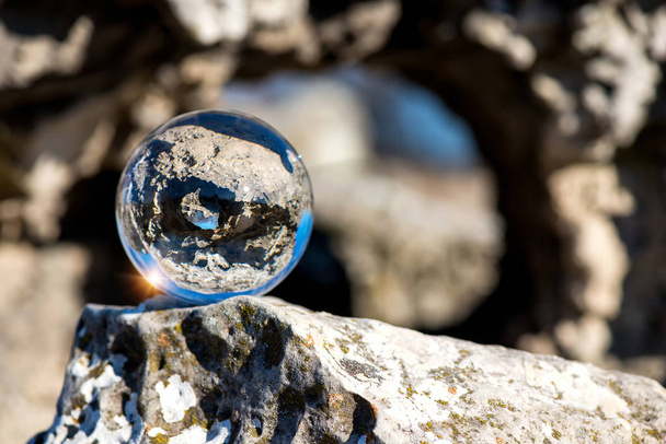 Upside down landscape of Pobiti Kamani, The Stone Forest Natural Reserve near Varna in Bulgaria, Eastern Europe - reflection in a lens ball - selective focus, space for text - Foto, Imagen