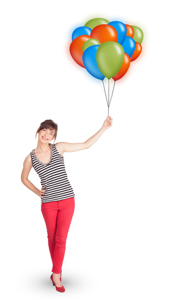 Young woman holding colorful balloons - Valokuva, kuva