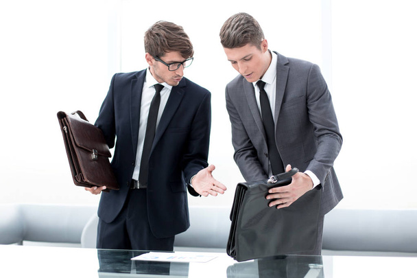 two business people discuss financial documents. - Fotó, kép