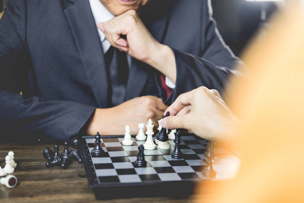 hand of businessman moving chess figure in competition board game for development analysis, strategy idea management or leadership concept - Foto, Imagen